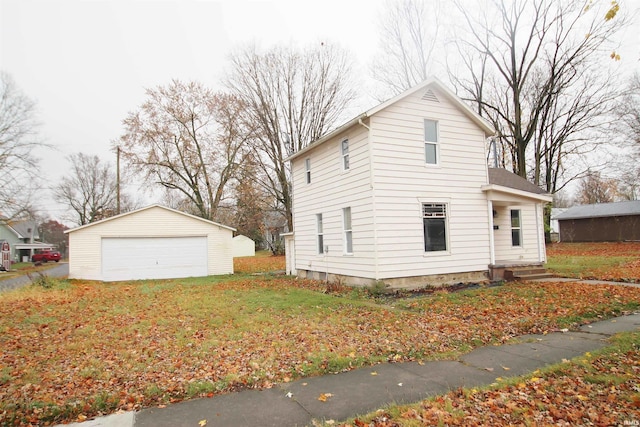 view of home's exterior featuring a garage and an outbuilding