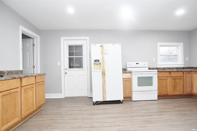 kitchen with light hardwood / wood-style flooring and white appliances