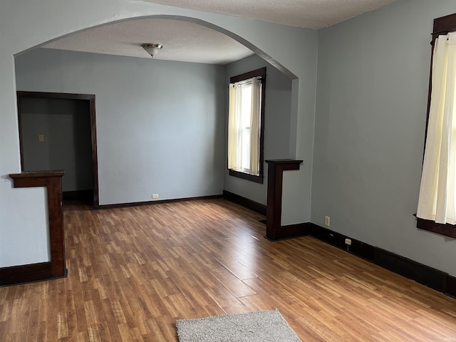 empty room featuring a textured ceiling and hardwood / wood-style flooring