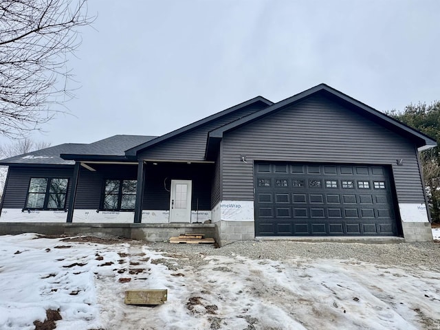 view of front of home with covered porch and a garage