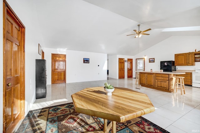 dining area featuring ceiling fan and lofted ceiling