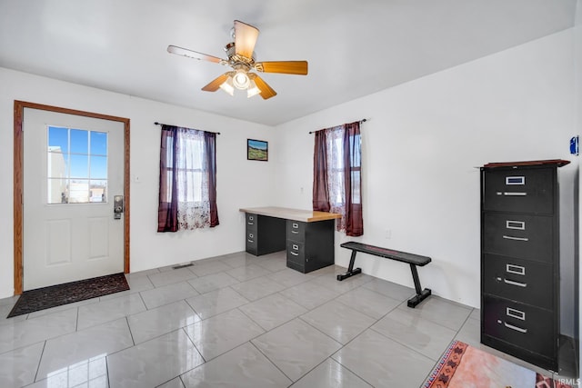 tiled entryway with ceiling fan