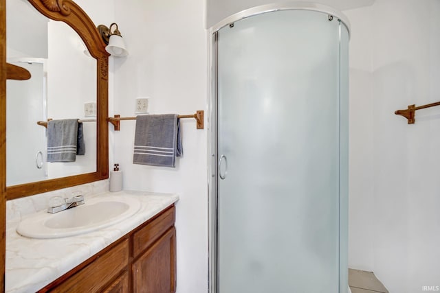 bathroom with an enclosed shower and vanity