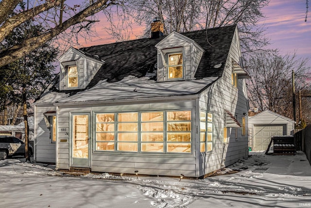 exterior space featuring a garage and an outdoor structure