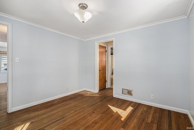 spare room featuring dark hardwood / wood-style floors and ornamental molding