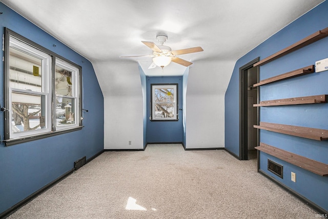 bonus room with ceiling fan, light carpet, and vaulted ceiling