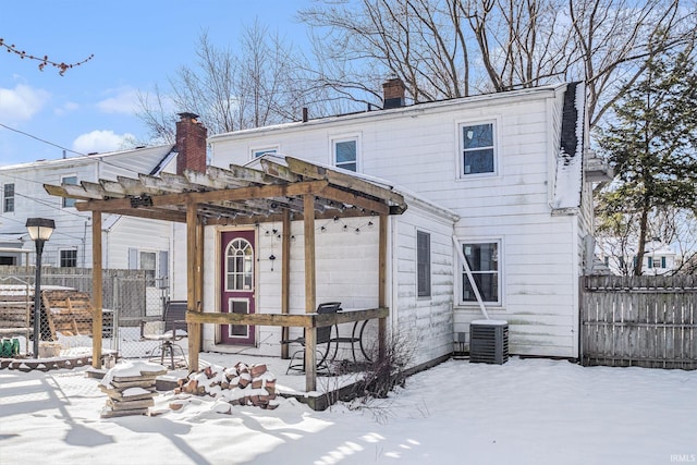 view of front of house featuring a pergola and cooling unit