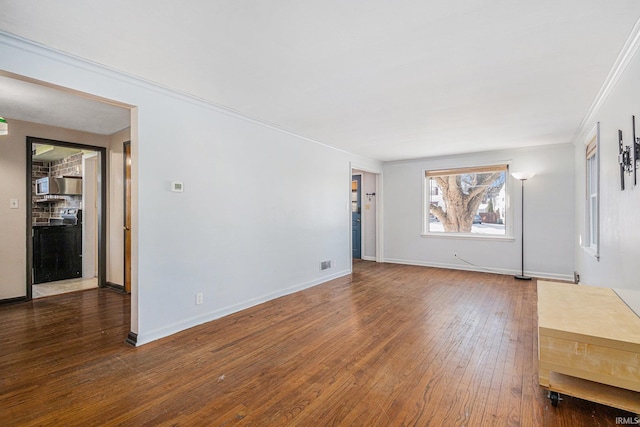 unfurnished room with dark hardwood / wood-style floors and ornamental molding