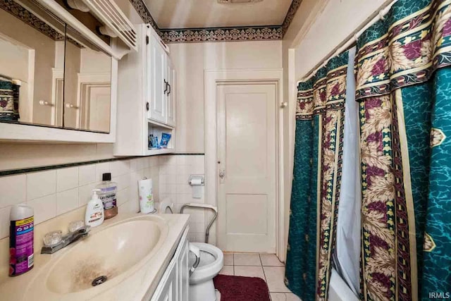 bathroom with toilet, vanity, tile patterned flooring, and walk in shower