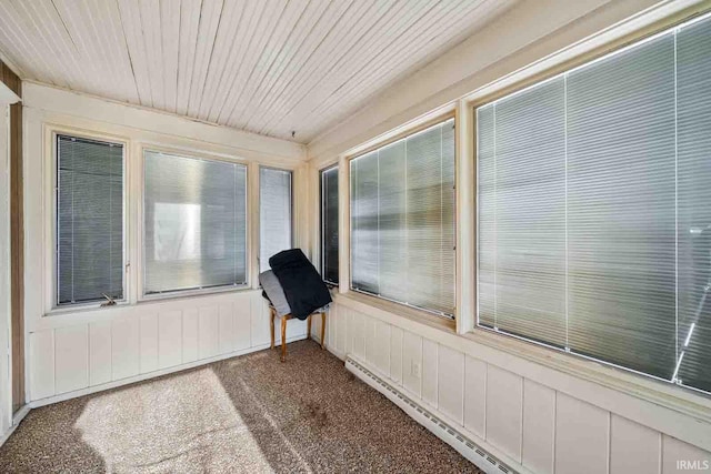 unfurnished sunroom featuring a baseboard heating unit