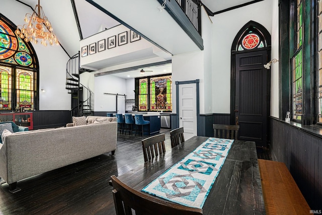 dining area with dark wood-type flooring and ceiling fan with notable chandelier