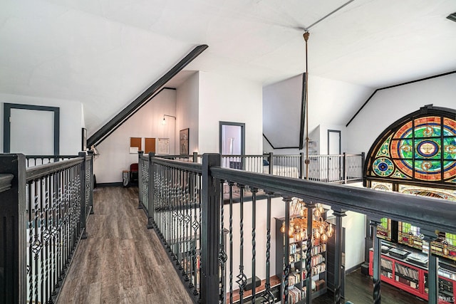 interior space with vaulted ceiling and dark hardwood / wood-style flooring