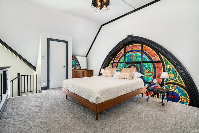 bedroom with lofted ceiling and carpet floors