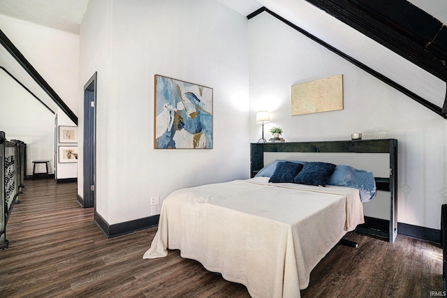 bedroom with dark hardwood / wood-style flooring and a high ceiling