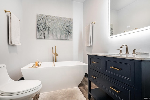 bathroom with toilet, wood-type flooring, a tub, and vanity