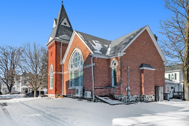 view of snowy exterior with ac unit