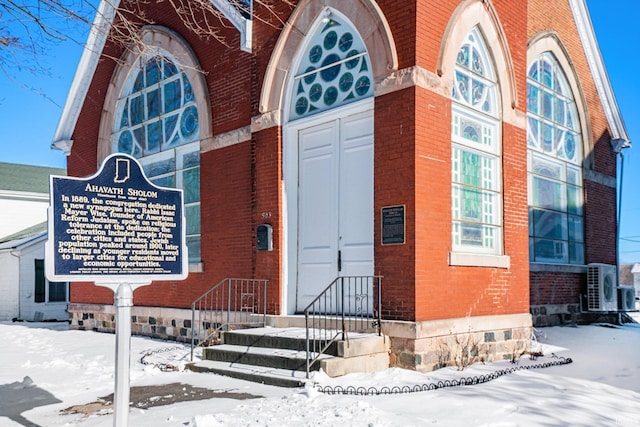 view of snow covered property entrance