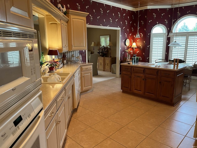 kitchen featuring white appliances, light tile patterned flooring, ornamental molding, and sink