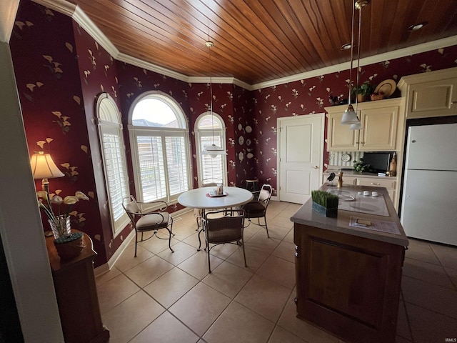 dining room featuring light tile patterned floors, crown molding, and wooden ceiling