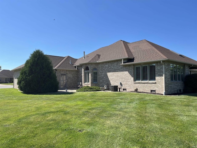 view of front of home with a front yard and cooling unit