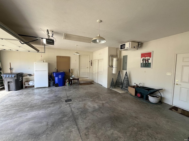 garage featuring a garage door opener, white refrigerator, and electric panel