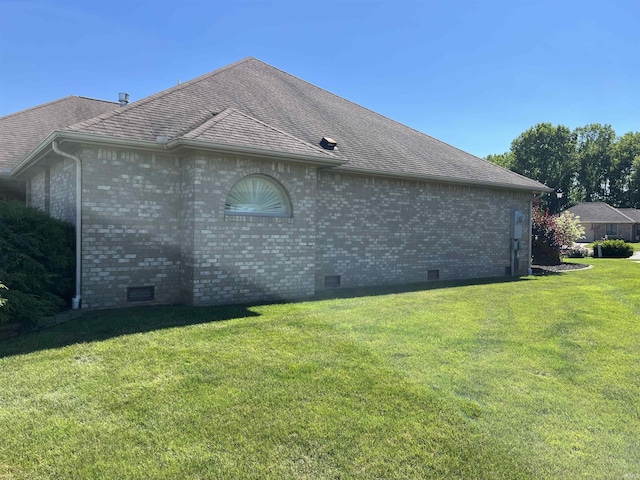 view of side of home with a lawn