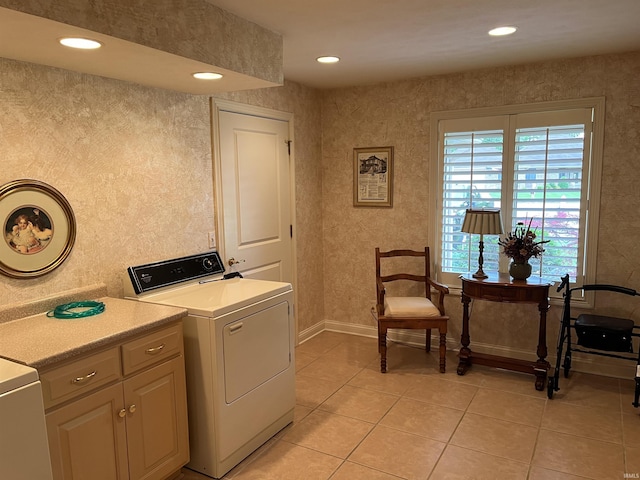 laundry area featuring light tile patterned floors and washer / dryer