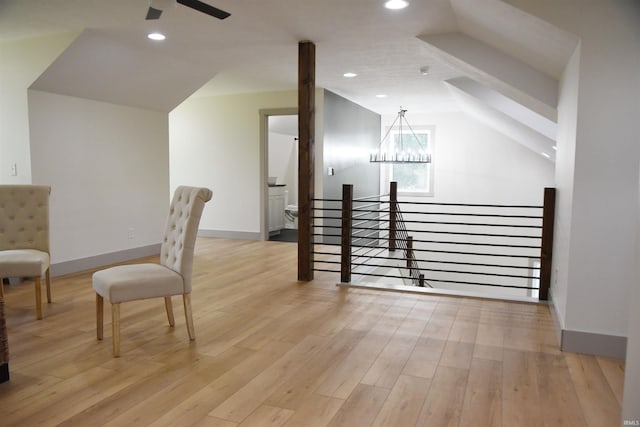 bonus room featuring light hardwood / wood-style flooring, lofted ceiling, and an inviting chandelier