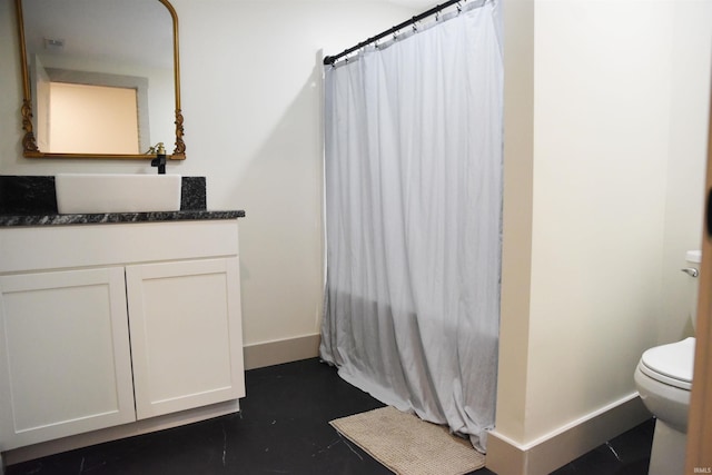 bathroom featuring curtained shower, toilet, and vanity