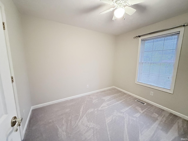 carpeted empty room featuring ceiling fan