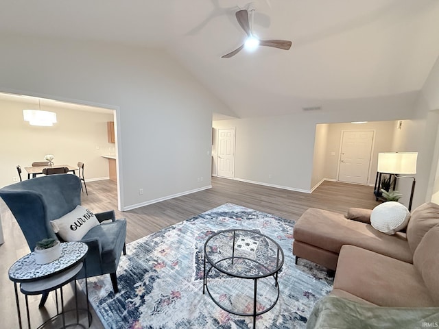 living room featuring ceiling fan, dark hardwood / wood-style floors, and lofted ceiling