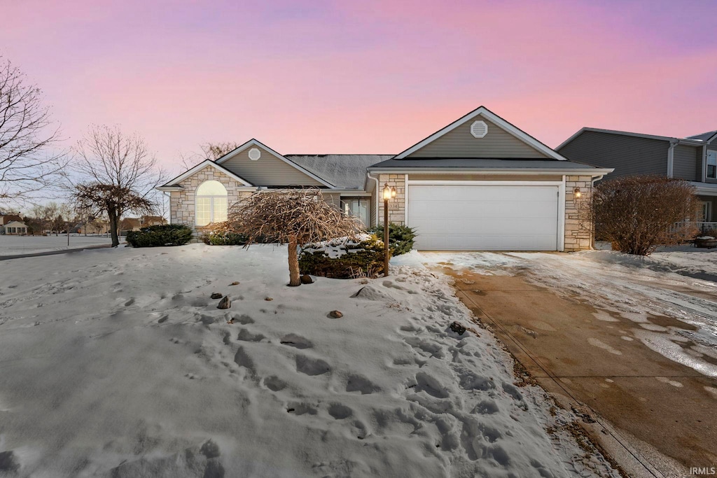 ranch-style home featuring a garage