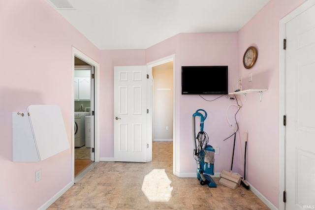 bedroom with washing machine and clothes dryer and ensuite bath