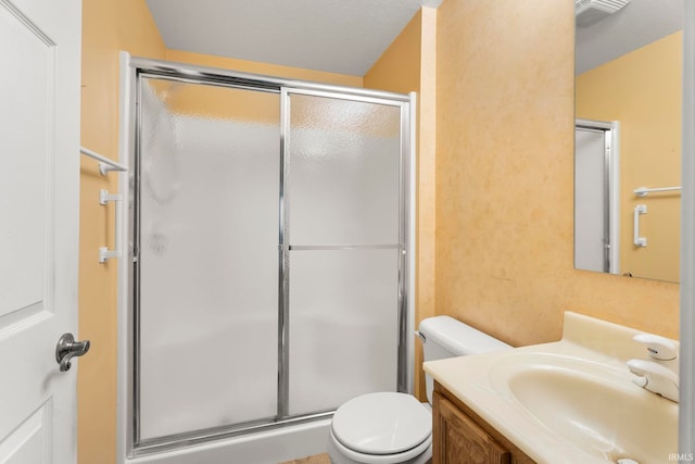 bathroom featuring a textured ceiling, toilet, an enclosed shower, and vanity