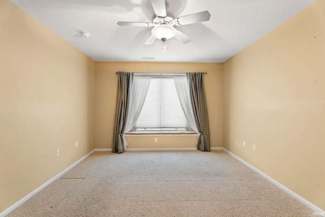 empty room featuring light carpet and ceiling fan