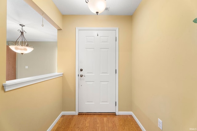 entryway with hardwood / wood-style flooring