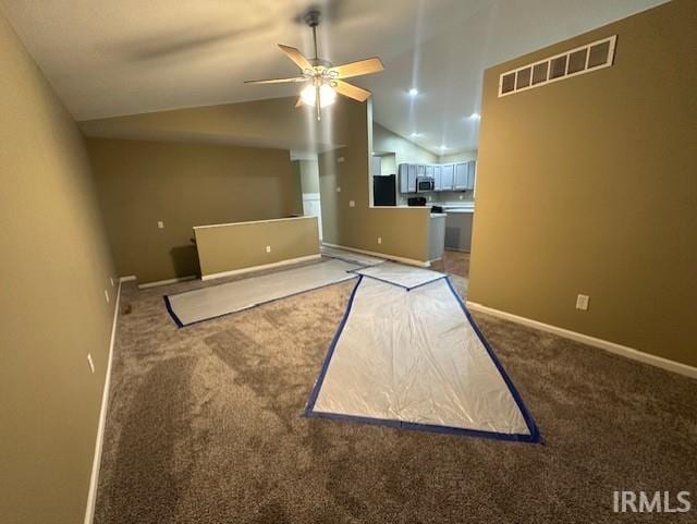 interior space with ceiling fan, carpet flooring, and lofted ceiling