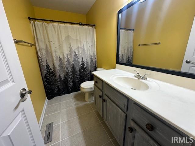 bathroom with toilet, vanity, and a shower with shower curtain