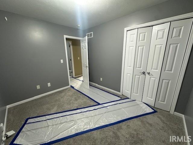 unfurnished bedroom featuring a closet and carpet