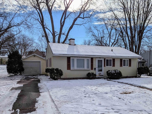 single story home with an outbuilding and a garage