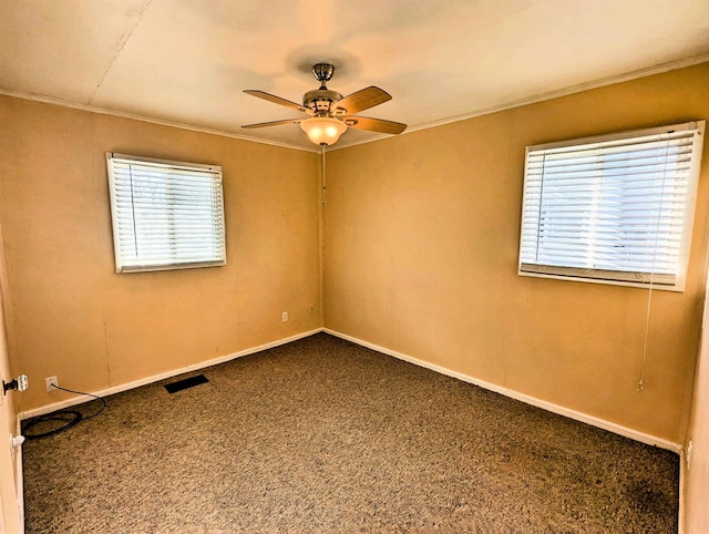 carpeted spare room featuring ceiling fan and crown molding