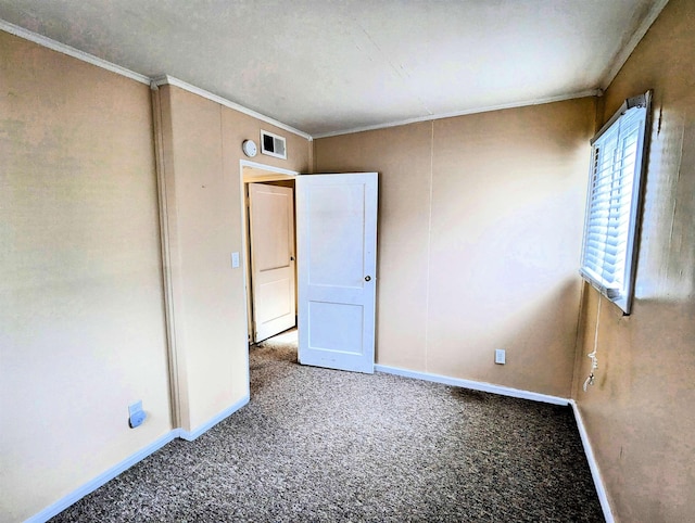 carpeted empty room featuring crown molding