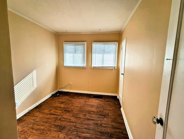 spare room with dark hardwood / wood-style flooring and ornamental molding