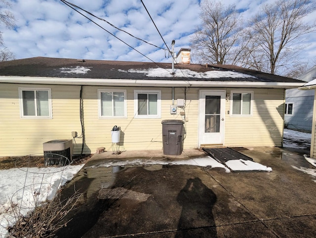 rear view of property with cooling unit