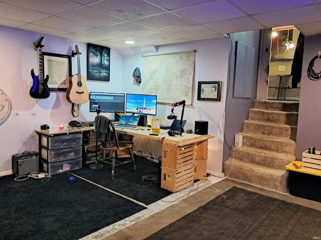 carpeted home office with a drop ceiling