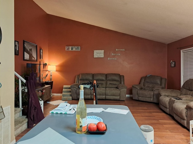 living room featuring lofted ceiling and hardwood / wood-style floors