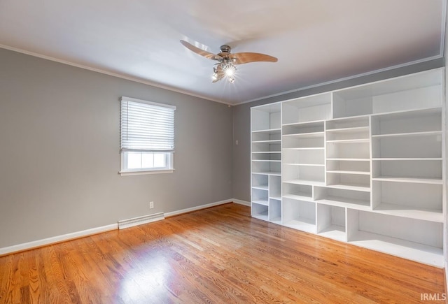 empty room with hardwood / wood-style flooring, ornamental molding, and ceiling fan