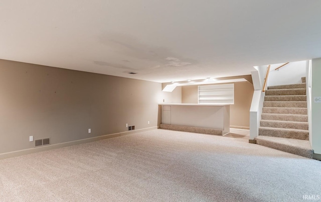 basement featuring light carpet