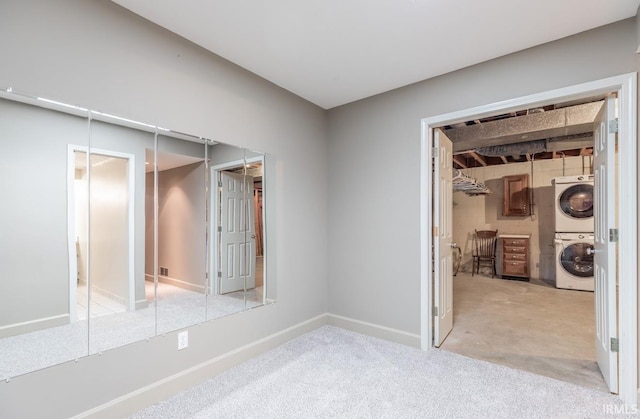 interior space with light carpet and stacked washer / dryer