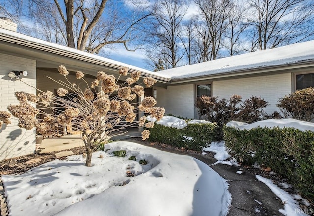 view of snow covered property entrance